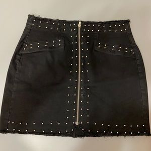 Black jean skirt with studs. Stretchy!